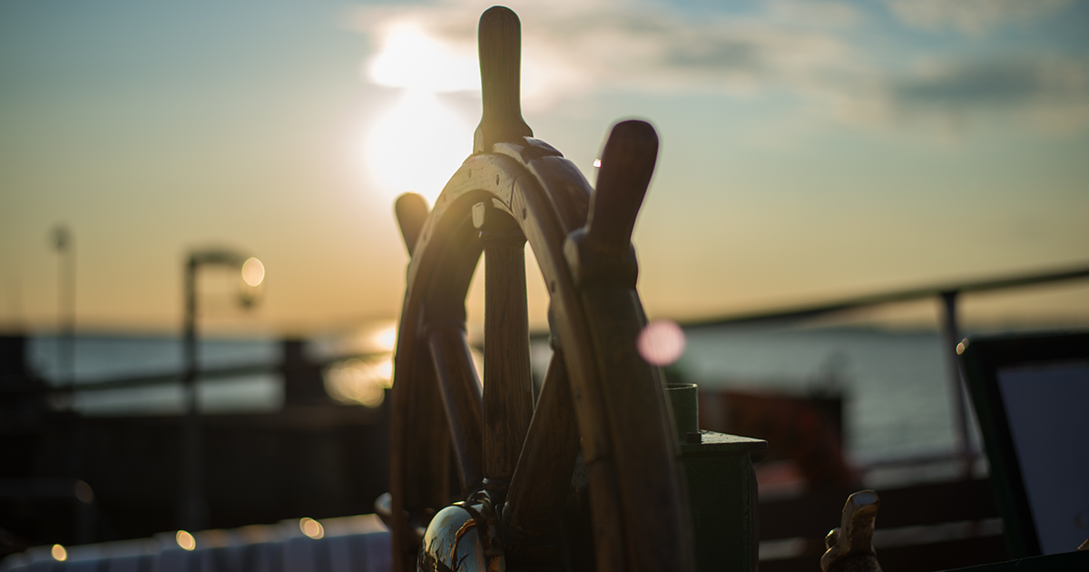 ship wheel at sunset